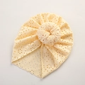 Close-up of cream lace hollow baby beanie with donut knot and breathable mesh texture - 21*19 cm / Beige
