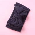 Detail of dark purple ribbed knit baby headband featuring a large oversized bow design - Navy Blue