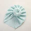 Detailed macro view of mint green hollow lace beanie with a stylish donut top knot - 21*19 cm / Emerald Green