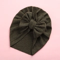 Detail view of moss green ribbed baby turban with a large decorative bow on pink background - 18x21cm / Army Green