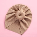 Close-up of baby beige ribbed knit turban hat featuring a soft donut knot detail - Dark Coffee