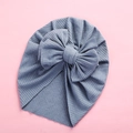 Detail of blue baby turban hat with a large bow and soft ribbed knit texture - 18x21cm / Blue