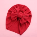Detail of red ribbed baby turban hat with a large soft decorative bow for newborns - 18x21cm / Red