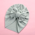 Detail of the soft ribbed knit texture and large bow design on the baby turban headwrap - 18x21cm / Bean Green