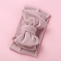Detail of soft ribbed knit baby headband with oversized bow in dusty pink color - Dark Pink
