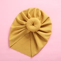 Detailed texture of yellow ribbed knit baby turban hat with a donut knot design - Ginger Yellow