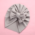 Close-up of soft ribbed fabric texture and large bow detail on baby turban hat - 18x21cm / Gray