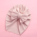 Detail of baby turban headwrap in pink ribbed knit fabric with a large soft bow - 18x21cm / Dark Pink