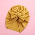 Detail view of ginger yellow ribbed knit baby turban with a large decorative bow - 18x21cm / Ginger Yellow