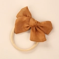 Close-up of linen bow texture and soft elastic nylon headband for newborns - Ginger Yellow