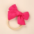 Detailed texture of rose red linen bowknot on soft beige elastic nylon baby headband - Rose Red