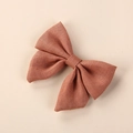Detailed macro view of handmade terracotta linen bow hair clip with natural fabric texture - 8*6.5 cm / Orange