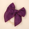 Detailed macro view of dark purple linen bow headband with exquisite embroidery edge - Deep purple