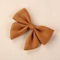Detailed macro view of the coarse linen texture on the mustard yellow handmade hair bow clip - 8*6.5 cm / Ginger Yellow