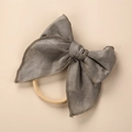 Detail of grey linen bow headband featuring textured fabric and elastic nylon band - Army Green