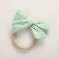 Close-up of mint green jacquard cotton bow with seamless nylon headband for babies - Verdant