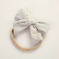 Detail of soft waffle fabric grey bow on a nude pink stretchy nylon baby headband - Gray