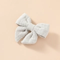 Close-up of light grey muslin cotton bow hair clip with natural woven texture - Light Gray