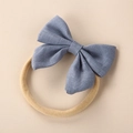 Close-up of blue linen fabric bow headband for babies with clear texture and elastic band - Grey Blue