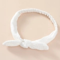 Detail of white cotton baby headband with bow knot and textured fabric finish - Pure White