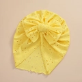 Detailed view of yellow baby turban hat featuring hollow embroidery and a large bow - Bright Yellow