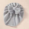 Close-up detail of a soft grey waffle knit texture on a newborn baby bow hat - 21*19 cm / Gray