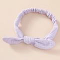 Detail of lavender cotton gauze baby headband featuring soft rabbit ear knot and elastic band - Purple