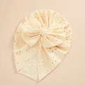 Detail of baby turban hat featuring eyelet embroidery and a large bow in cream white - Beige