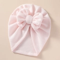 Close-up of baby waffle knit hat in light pink with a large decorative soft bow detail - 21*19 cm / Light Pink