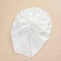 Detailed macro view of pure white baby lace turban with intricate floral embroidery and bow - White