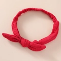 Detail shot of the red cotton bunny ear headband with textured fabric and elastic band - Red