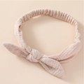 Close-up of a soft pink cotton baby headband with a decorative knot and elastic texture - Light Khaki