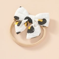 Close-up of baby headband with a soft leopard print cotton bow and stretchy nylon strap - Leopard Print