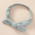 Detail of baby headband featuring soft wrinkled light blue cotton fabric and large bow - Bean Green