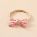 Dettaglio di un fiocco in lino rosa su una fascia elastica in nylon per neonati - Rosa Medio