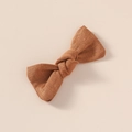 Vue détaillée du nœud en lin marron avec une texture tissée naturelle et douce - Brun