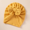 Close-up of yellow baby turban hat with oversized bow and textured waffle knit fabric - 21*19 cm / Gold Yellow