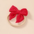Detail of red muslin bow on soft elastic nylon headband for newborn babies - Red