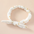 Detailed view of white floral cotton headband with rabbit ear bow and elastic texture - Yellow Floral