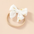 Close-up of soft floral cotton bow with high-elasticity nylon headband for infants - Yellow Floral