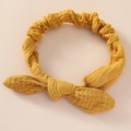 Detailed texture of ginger yellow cotton bunny ear headband with elastic wrinkled fabric - Turmeric