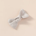 Detail shot of solid color linen bow hair clip with natural fabric texture for girls - Off White