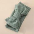Detailed close-up of sage green knitted baby headband with a large bow and ribbed texture - 6# Bean Green