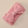 Close-up of pink ribbed nylon baby headband with a large soft decorative bow - Pink