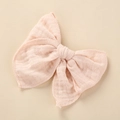 Close-up of large pale pink muslin cotton bow hair clip with natural crinkled texture - 10.5x10.5cm / Light Pink