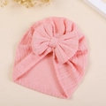 Detail shot of pink baby turban hat showing delicate knit texture and large bow - M / Peach Pink