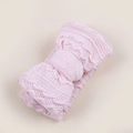 Detailed macro view of pink knitted baby headband with a layered bow and textured pattern - Soft Pink
