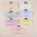 Flat lay of seven knit baby headbands with large bows and hollow mesh texture - 15.5x8.5cm / Random Color
