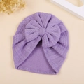 Detail of purple knitted baby turban hat with wheat ear bow and delicate V-stitch texture - M / Purple