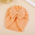 Detail of warm orange knitted baby turban hat with wheat ear texture and large bow - M / Bright Orange